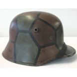 A British made film prop from D.K.H. Film of a German WWI M18 helmet with painted camo detail.