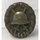 A WWI style Imperial German Silver wound, pin back badge.