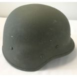 A 1998 Italian Army kevlar helmet with interior suspension lining and chin strap.