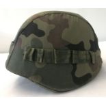 A Polish M93 Kevlar helmet with canvas camo cover and interior suspension lining.