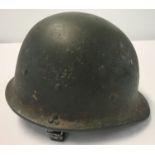 A circa 1991 Gulf War Iraqi helmet with interior canvas suspension lining and chin strap.