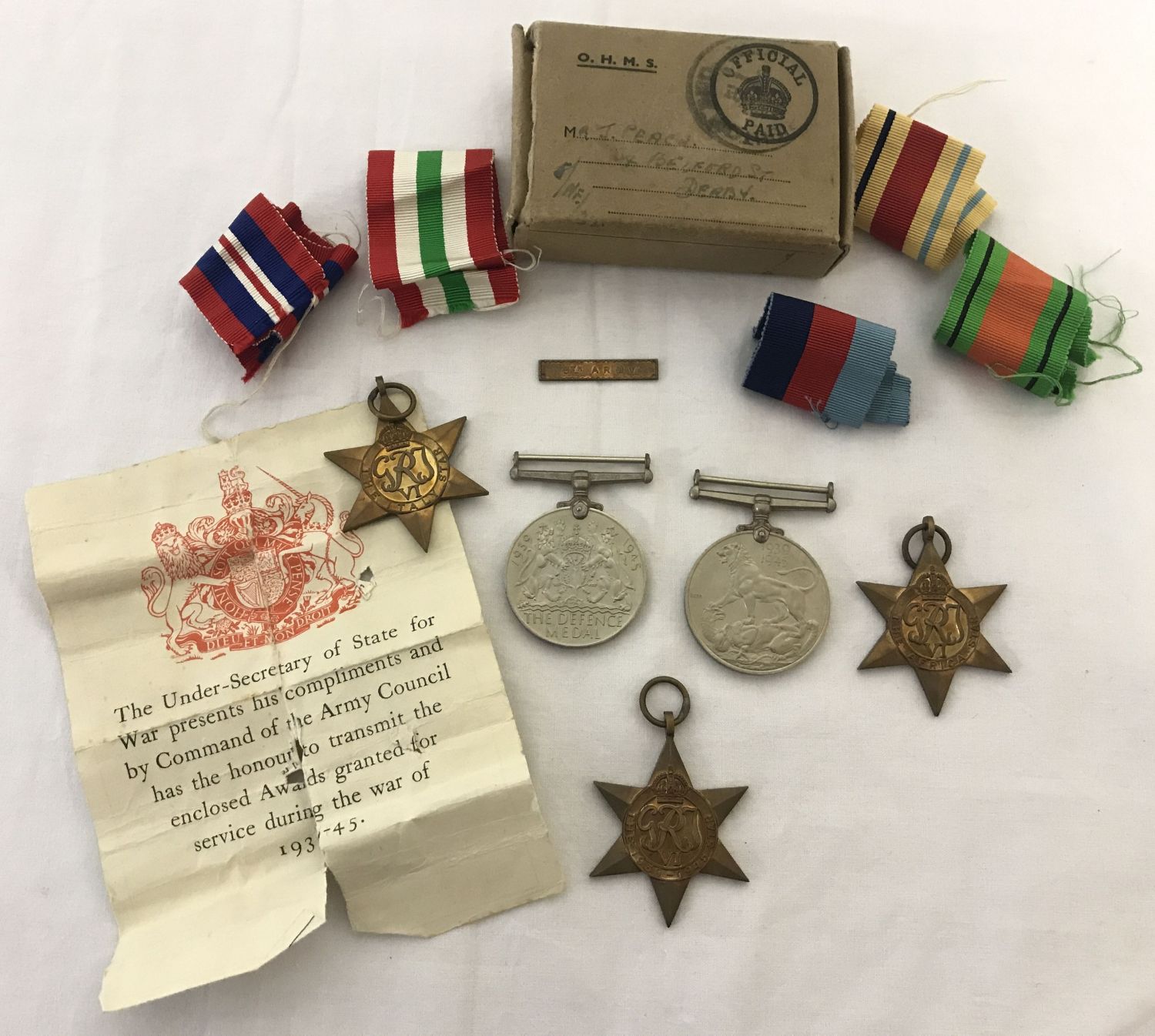 5 unworn WWII medals awarded to Private J Peach on his discharge from the army in 1948.