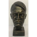 A cast metal bronzed figurine of Adolf Hitler's head.