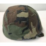 An Italian Kevlar Paratrooper's helmet, circa 1995, with canvas camo cover.