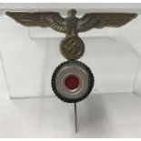 A WWII style Kreigsmarine "Donald Duck" eagle and cockade cap badge.