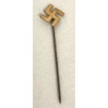 A 9ct gold swastika lapel pin.
