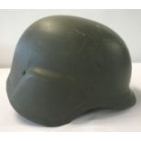 A Serbian M97 Kevlar helmet with interior suspension lining and canvas & velcro chin strap.