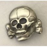 A WWII style Waffen SS Totenkopf visor skull badge.