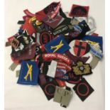 A large quantity of WWII style cloth badges and patches.