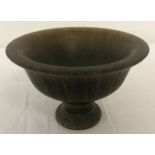 A circular shaped libation cup raised on a central pedestal base.