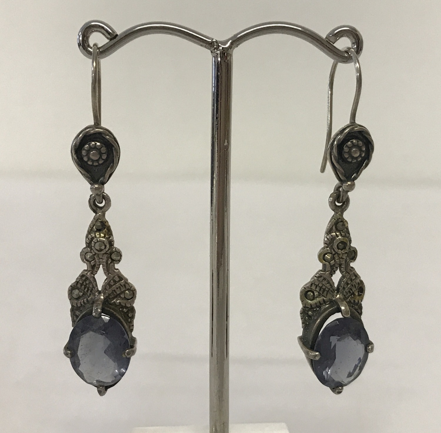 A pair of white metal vintage style drop earrings set with large blue stones and marcasite's.