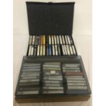 2 large cases of assorted vintage cassette tapes, approx. 65 tapes in total.