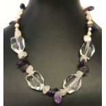 A decorative amethyst, rose quartz, clear quartz and freshwater pearl necklace with t bar clasp.