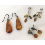 3 pairs of silver amber set earrings.