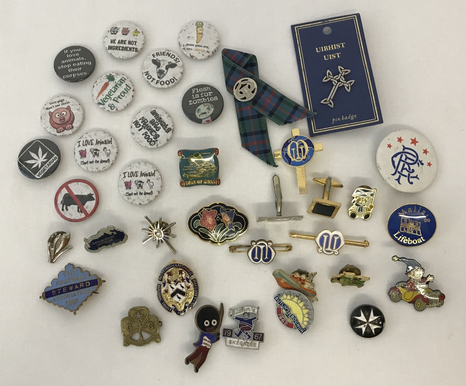 A collection of vintage and modern pin and button badges.