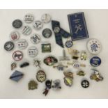 A collection of vintage and modern pin and button badges.