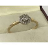 A vintage Art Deco style 18ct diamond set dress ring of flower head design.