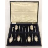 An antique cased set of silver Apostle spoons and matching sugar tongs.