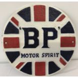 A cast iron circular shaped BP wall hanging plaque, painted in red, white and blue colours.