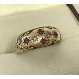 An antique 9ct gold diamond and ruby set gypsy style ring.