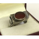 A contemporary style silver dress ring set with a oval cut carnelian stone.
