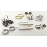 8 pairs of silver and white metal earrings in both stud and drop designs.