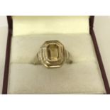 A 9ct gold citrine set dress ring. Octagon cut stone in a stepped octagon mount.