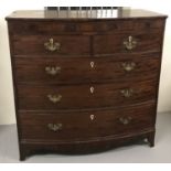 A Victorian dark wood bow fronted 5 drawer chest with brass drop down handles.