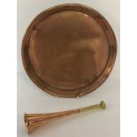 A small vintage copper and brass hunting horn together with a circular copper tray.