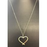 A 9ct gold open heart pendant on a fine curb chain.