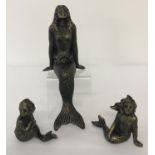 A set of 3 bronzed cast metal mermaid figurines.