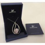 A large teardrop caged style pendant necklace by Swarovski complete with box and CAO.