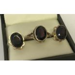 A 9ct gold garnet set dress ring and matching stud style earrings.