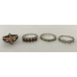 4 silver dress rings. A garnet set eternity style ring, an eternity ring set with clear stones,