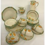 A collection of vintage Tea and dinner ware. Cream ground with orange and green floral decoration.