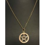 A 9ct gold pentagram pendant with engraved decoration on an 18 inch fine curb chain.