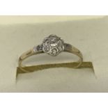A diamond set 18ct gold and platinum dress ring of flower head design.
