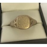 A men's 9ct gold signet ring with engraved decoration and empty cartouche to top.