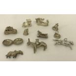 A small collection of white metal charms to include button, car, boot and a church.