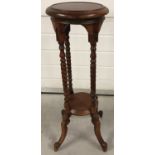 A mahogany four columned plant stand with turned pedestals and feet.