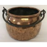 A large Victorian copper swing handled cooking cauldron.