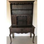 A vintage dark oak 2 sectional dresser.