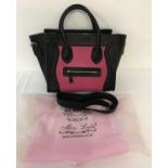 A brand new ladies handbag by Miss Lulu. Black and pink, crocodile patterned faux leather.