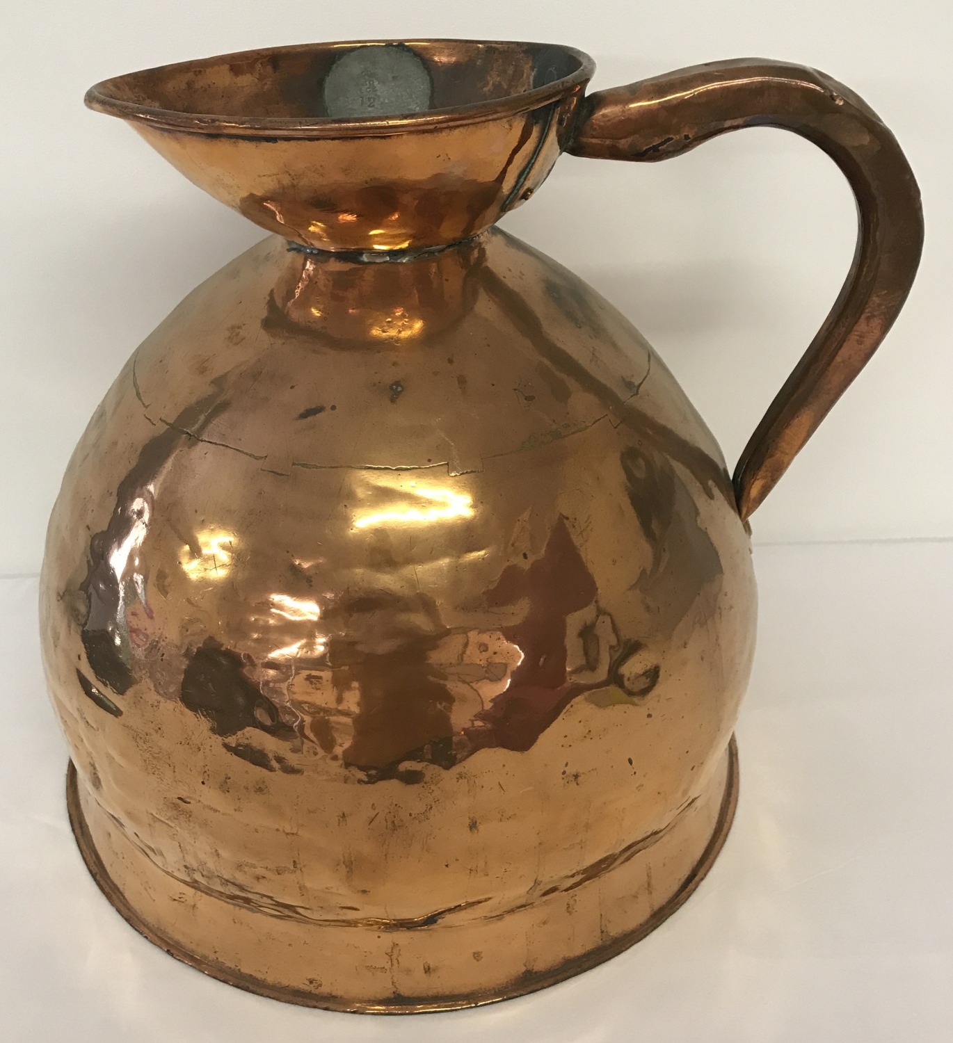 A Georgian copper 4 gallon ale jug of bulbous form, with leaded stamp and GR mark.