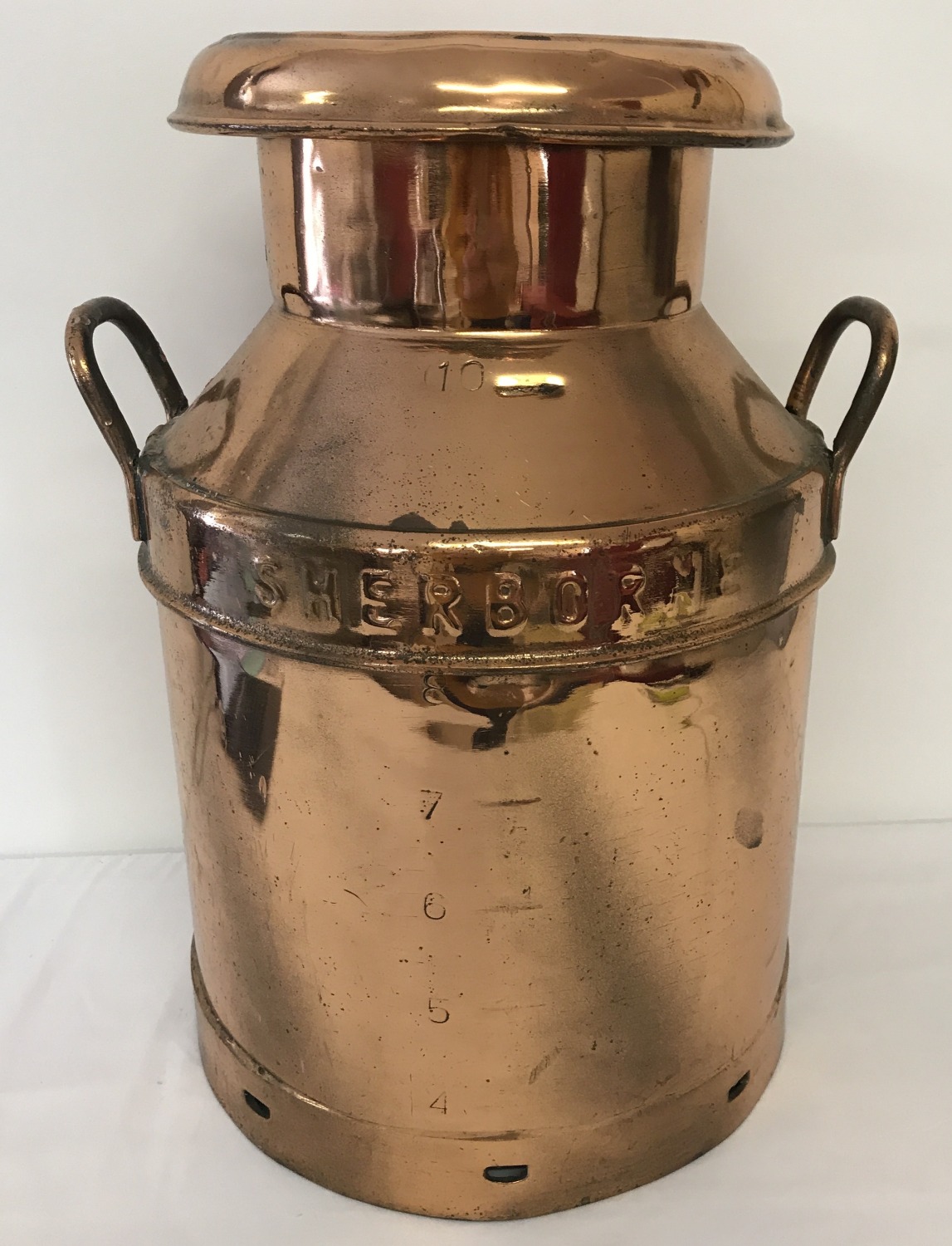 An antique copper 2 handled 'Hunts Dairies, Sherborne', milk churn with embossed name to sides.