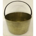 A very large, heavy, Victorian brass saucepan with fixed handle.