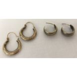 2 pairs of gold hoop style earrings.