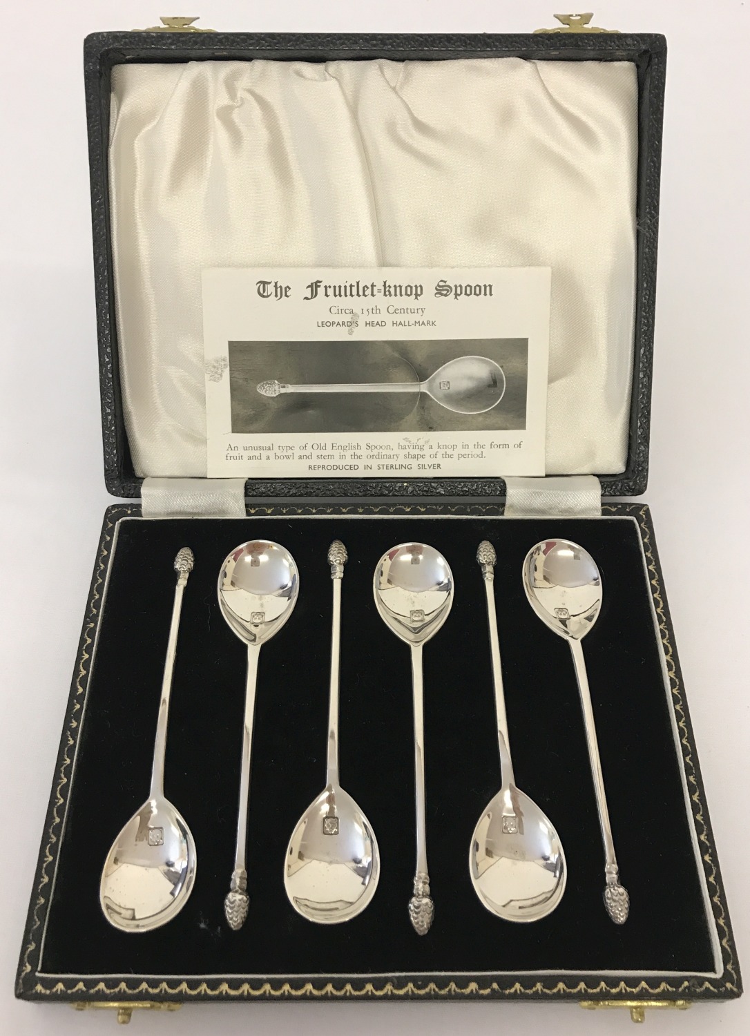 A case set of 6 silver "The Fruitlet-Knop" spoons.