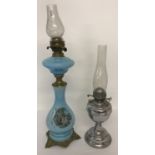 A vintage blue glass 2 tier oil lamp with transfer printed detail to lamp base