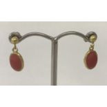 A pair of coral set,small oval, drop style earrings. Tests as 22ct gold.